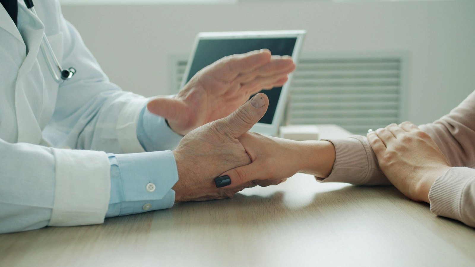 Doctor reassuring a patient with a hand on their arm