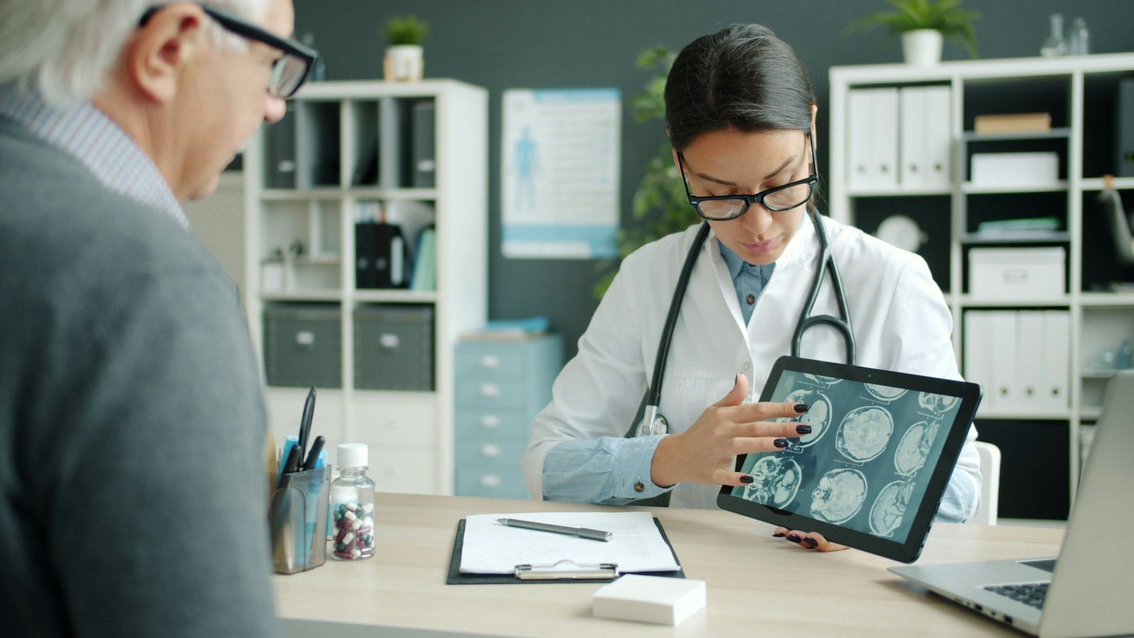 Dr. Calloway reviewing scan results on a tablet with an older patient