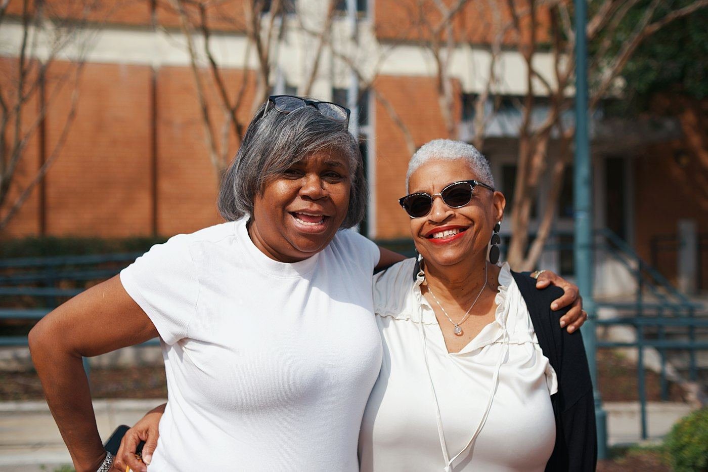 Two older women smiling together outdoors