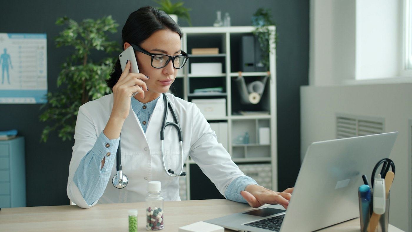 Dr. Calloway taking a member's call at her desk